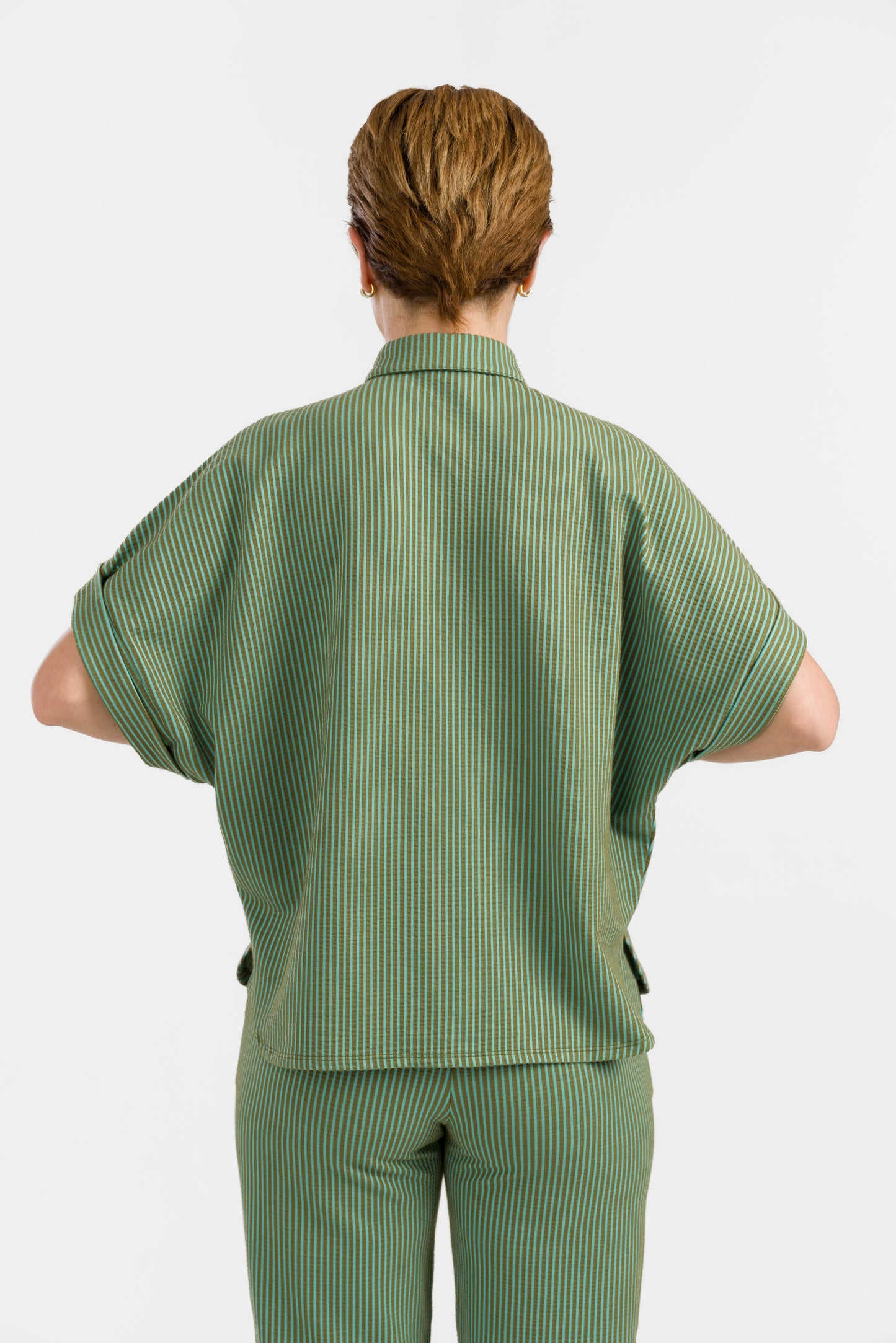 Grün-hellgrün gestreifte Seersucker Bluse in Loosefit Style mit Bubikragen und weit üerschnittenem kurzen Ärmel mit Aufschlägen- Vorne geknöpft.