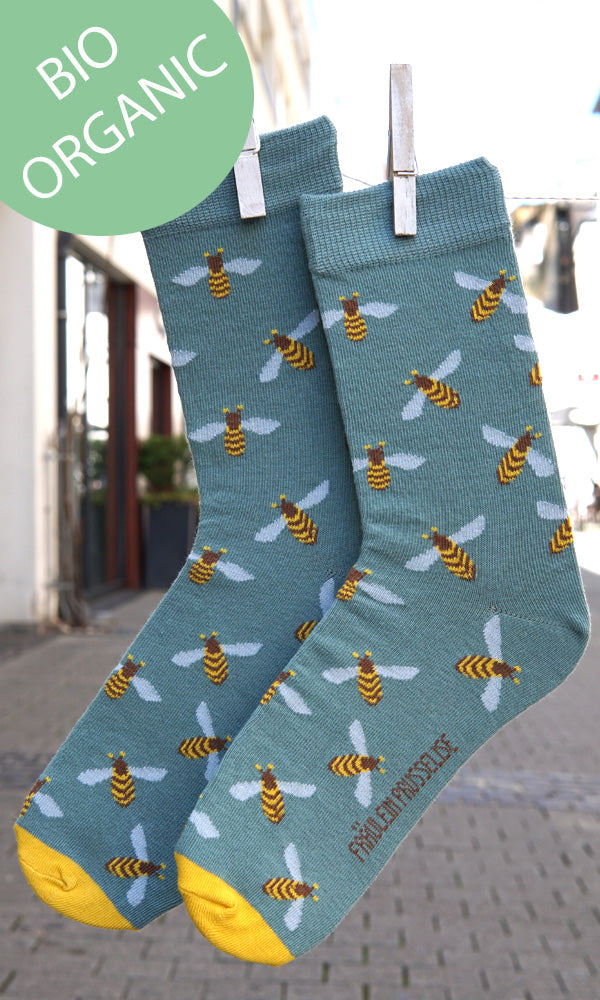 Socken mit Bienenmuster in blau und gelb.